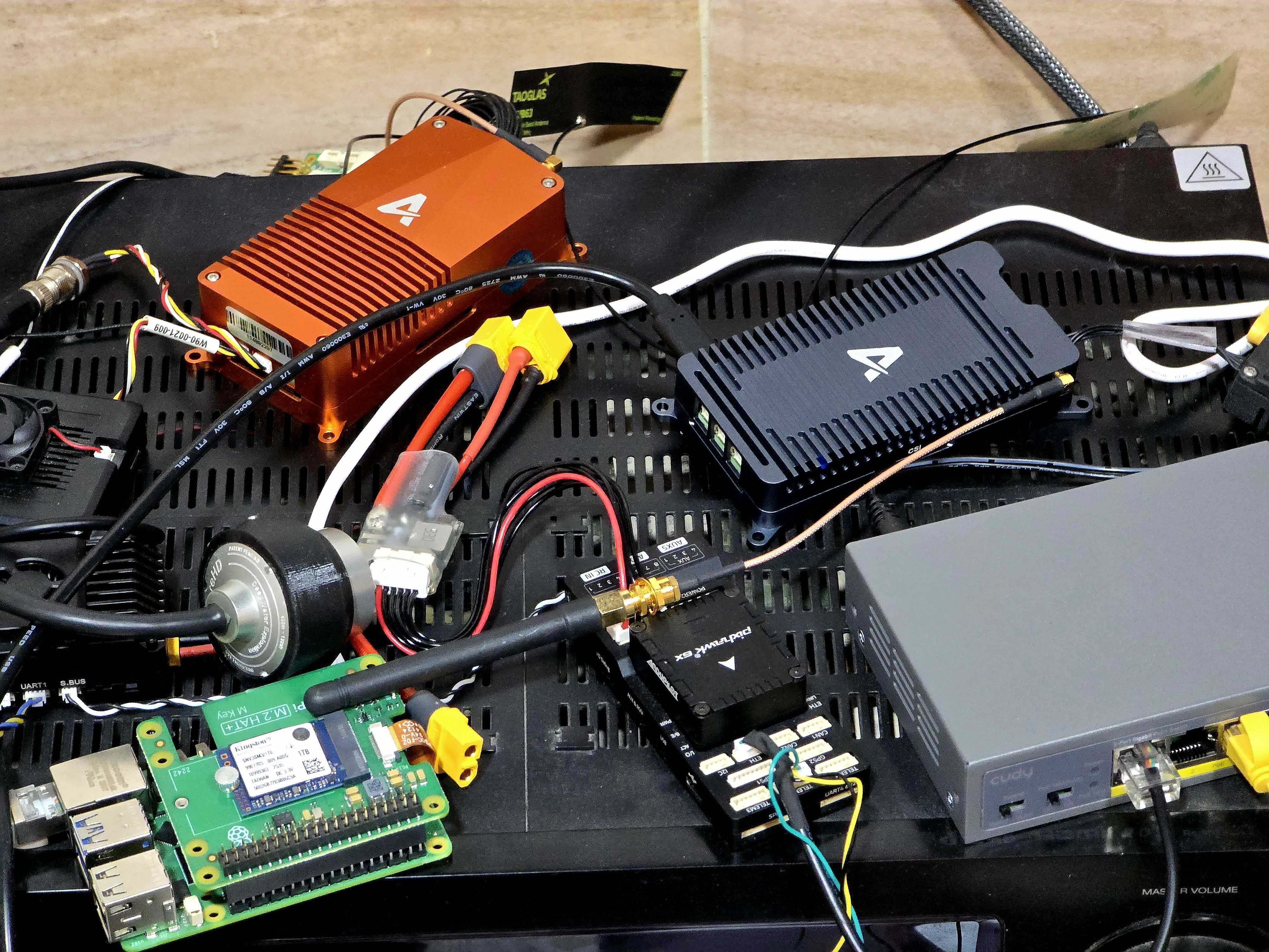 Hardware-in-Simulator bench — Skynode X + Skynode Enterprise + motor controller